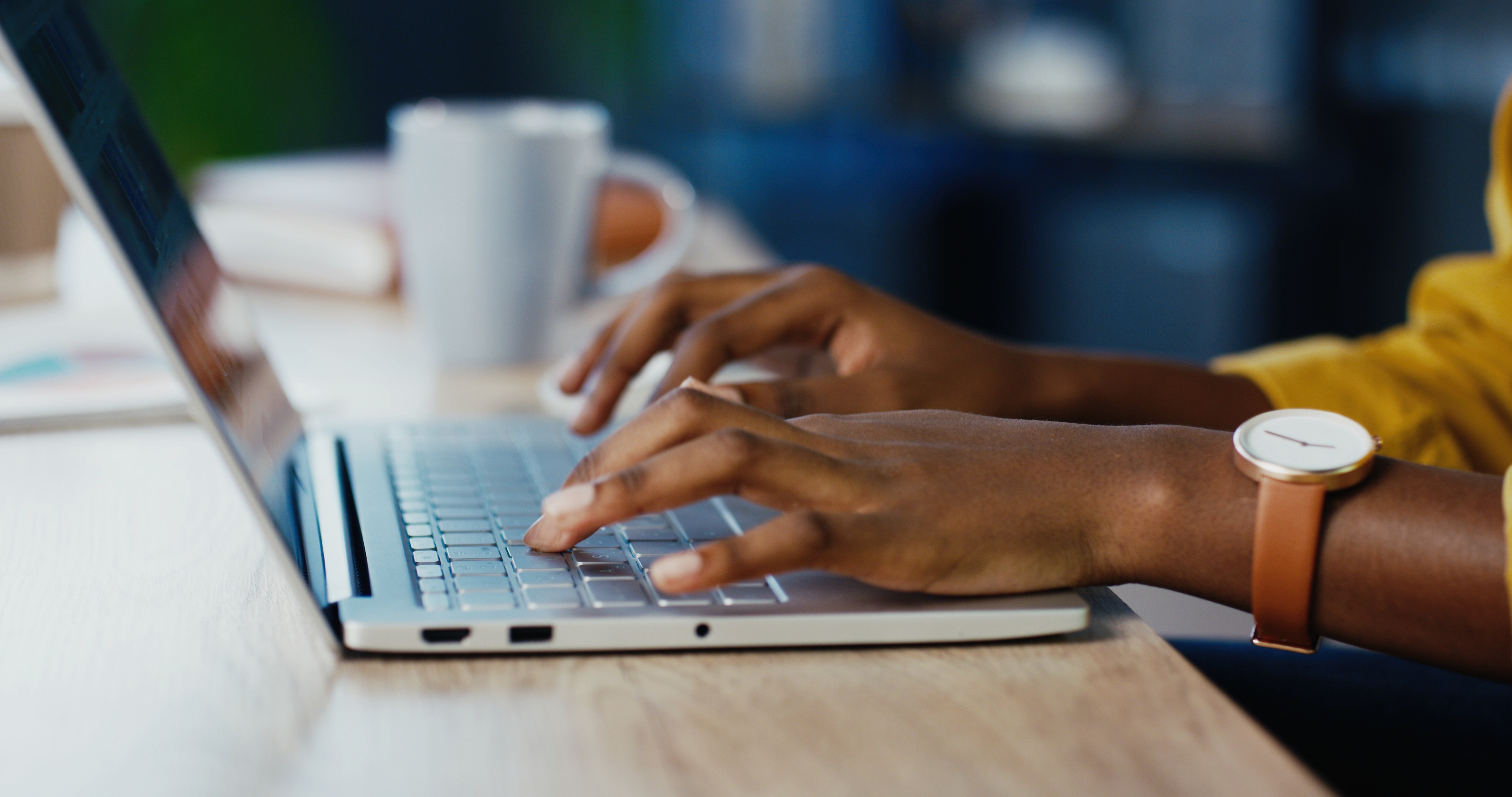 hands typing on a laptop