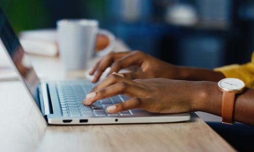 hands typing on a laptop